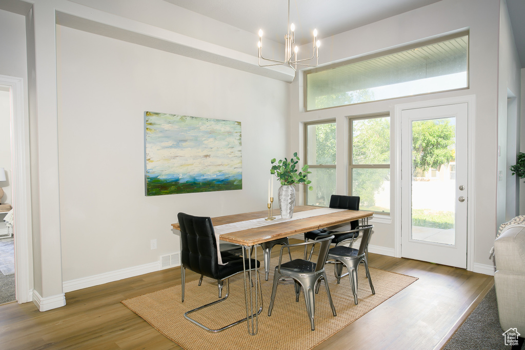 Dining area with a chandelier and wood finished floors