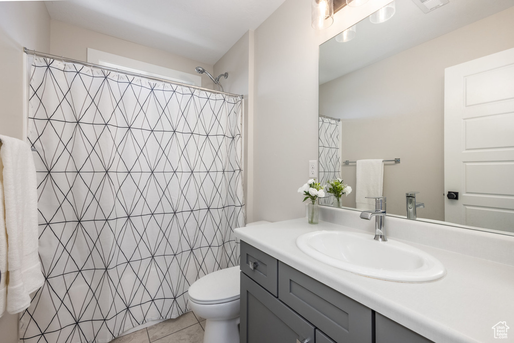 Full bath featuring vanity, tile patterned flooring, and curtained shower
