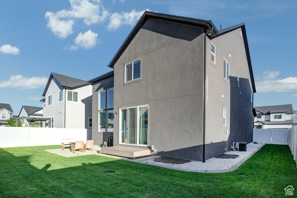 Back of property featuring a fenced backyard, stucco siding, and a residential view
