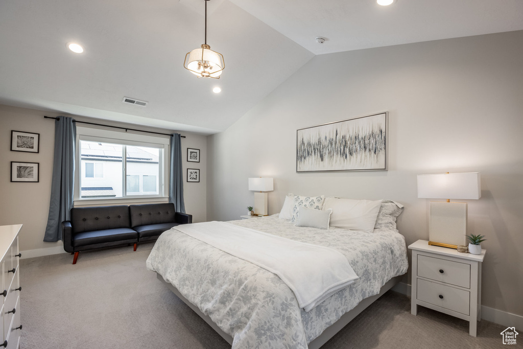 Bedroom featuring light colored carpet, lofted ceiling, and recessed lighting