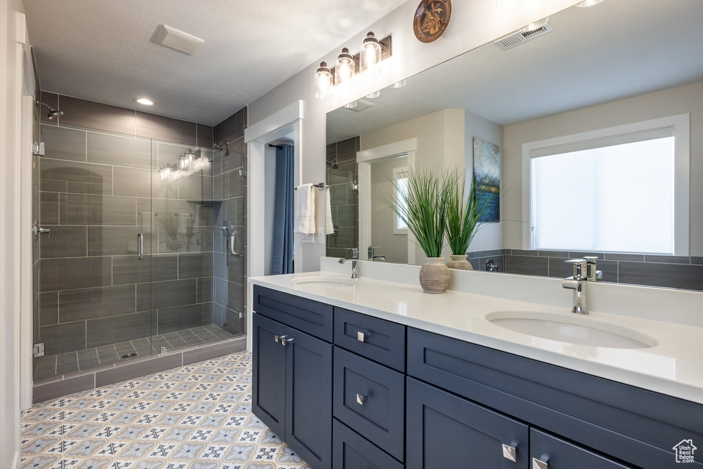 Bathroom with a stall shower and double vanity
