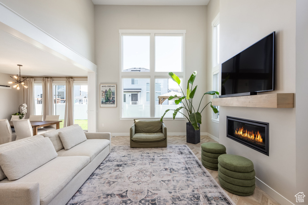 Living area with a chandelier and a glass covered fireplace