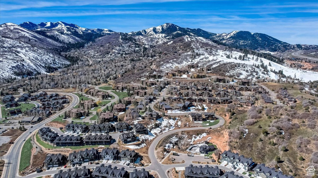 Aerial overview of property's location featuring a mountain backdrop