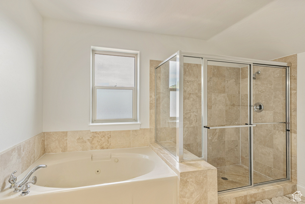 Bathroom with a garden tub and a shower stall