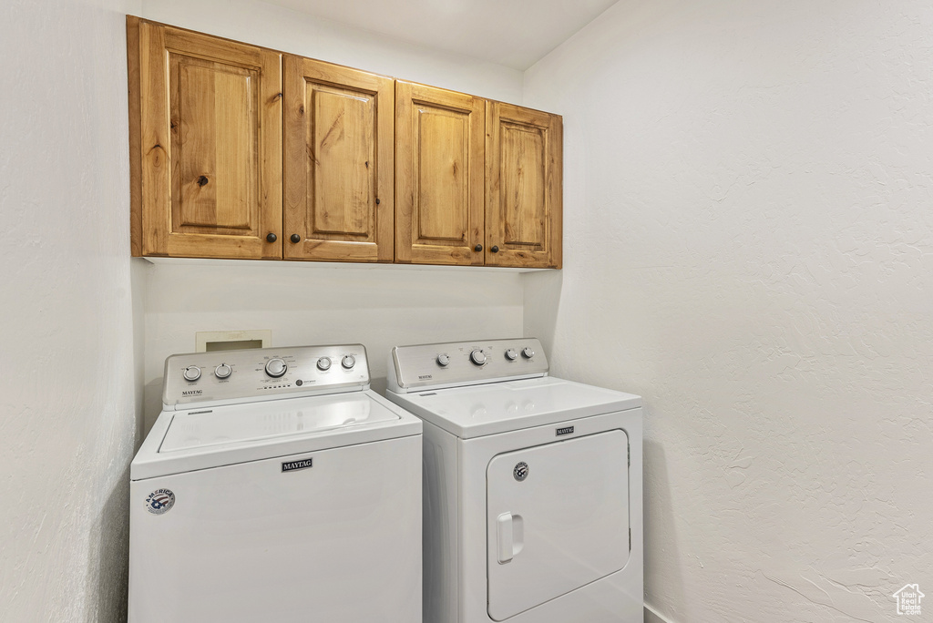 Laundry area with cabinet space and washer and dryer