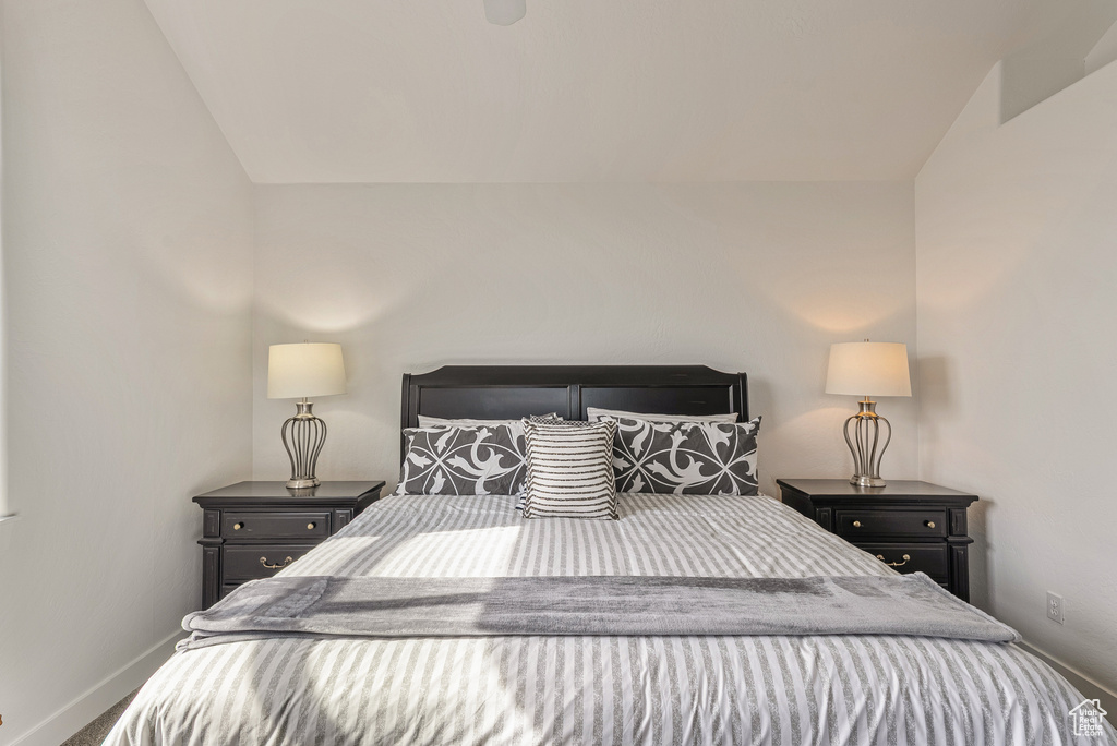 Bedroom featuring vaulted ceiling and carpet flooring
