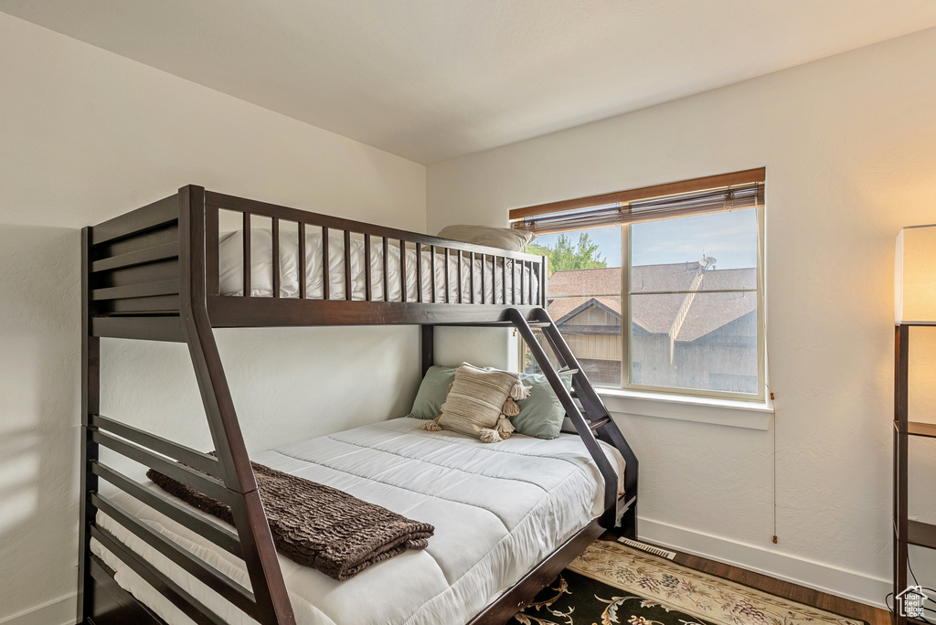 Bedroom with baseboards and wood finished floors