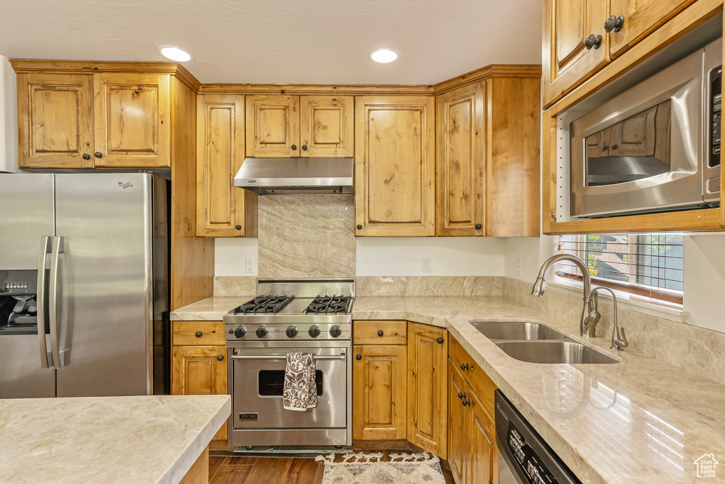 Kitchen featuring appliances with stainless steel finishes, under cabinet range hood, light countertops, and recessed lighting