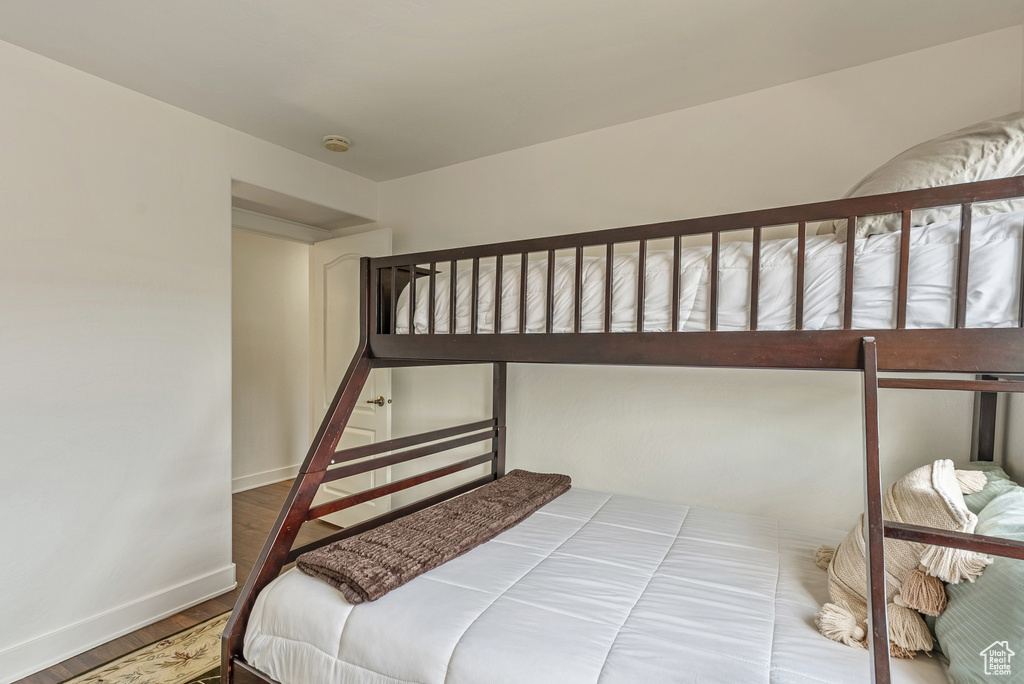Bedroom featuring baseboards and wood finished floors