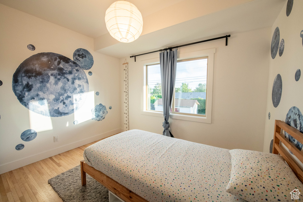 Bedroom featuring wood finished floors and baseboards
