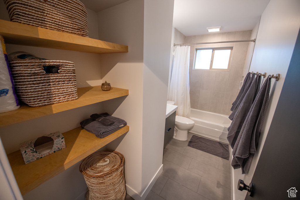 Bathroom featuring tile patterned floors and shower / bath combination with curtain