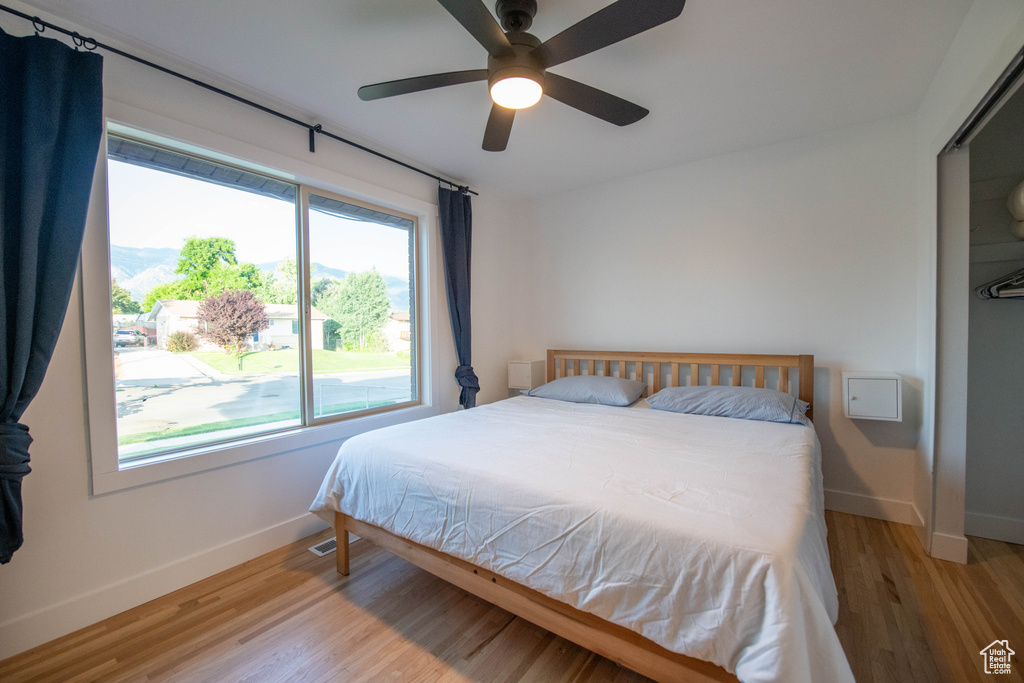 Bedroom with light wood-style floors and ceiling fan