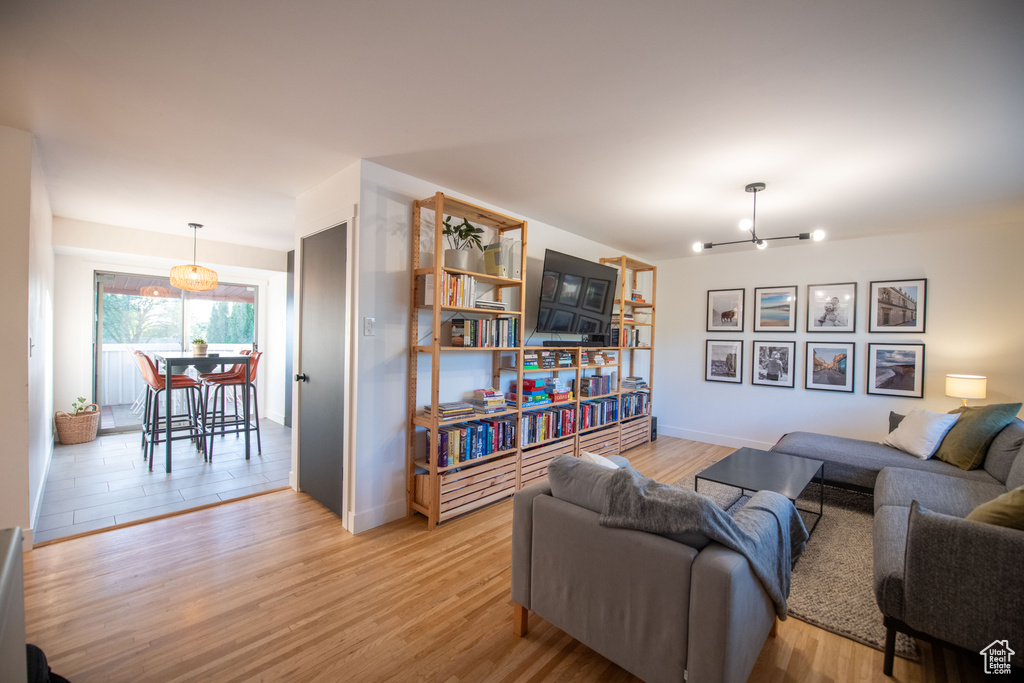 Living area featuring a chandelier and light wood-style floors