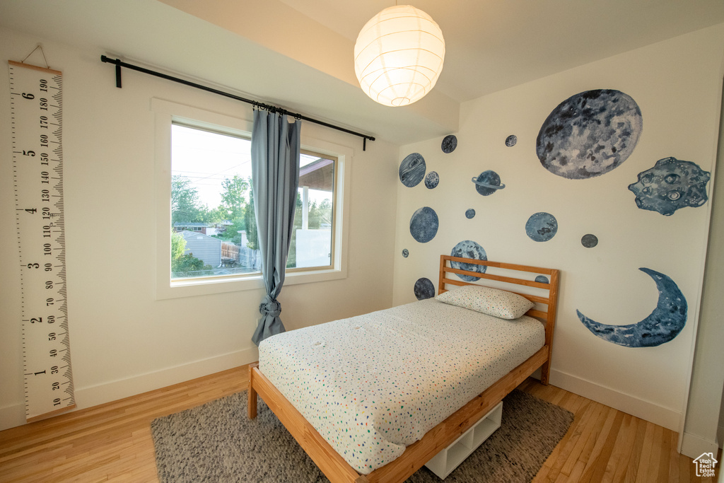 Bedroom with baseboards and light wood finished floors