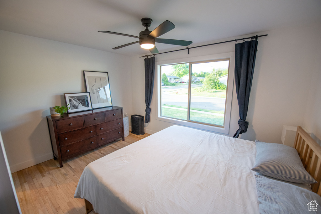 Bedroom with light wood finished floors and ceiling fan