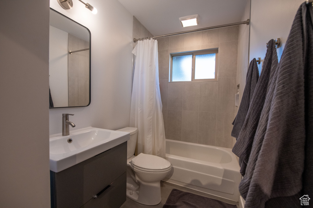 Full bathroom with vanity and shower / bath combo with shower curtain