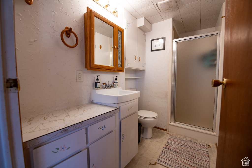 Bathroom featuring vanity and a shower stall