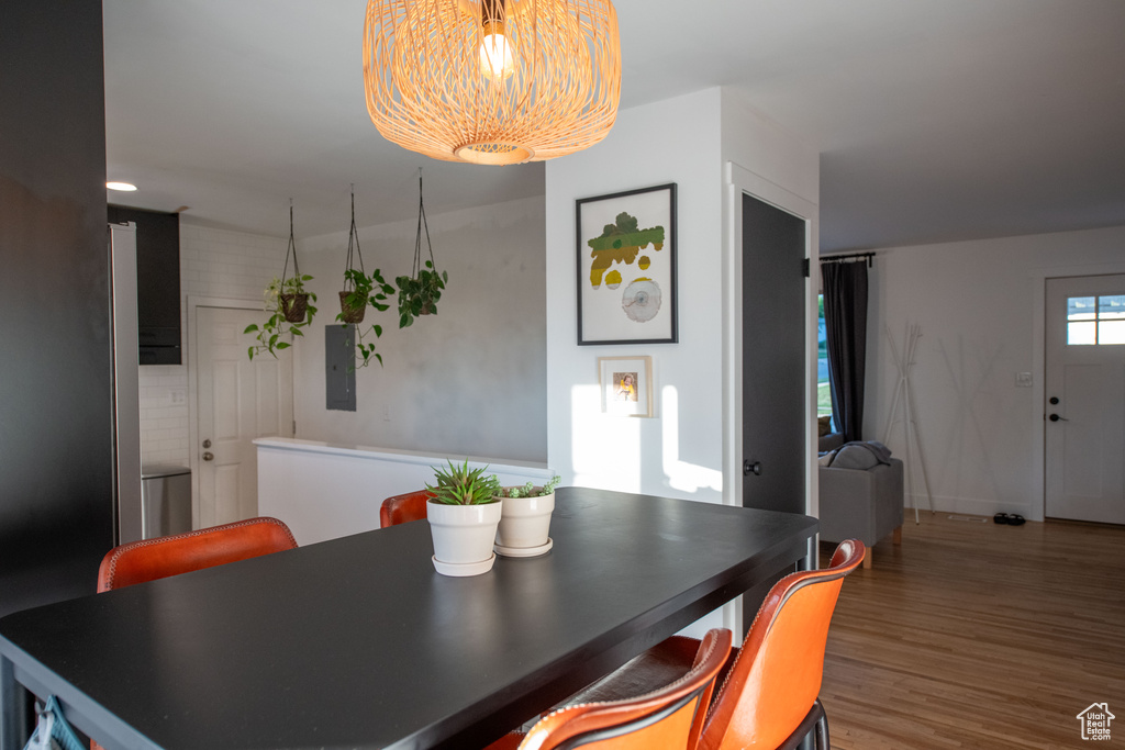 Dining room with electric panel and wood finished floors