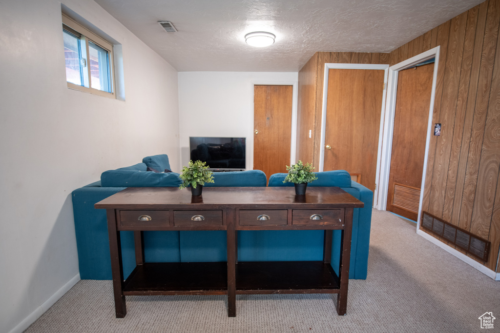 Living area featuring carpet flooring and baseboards
