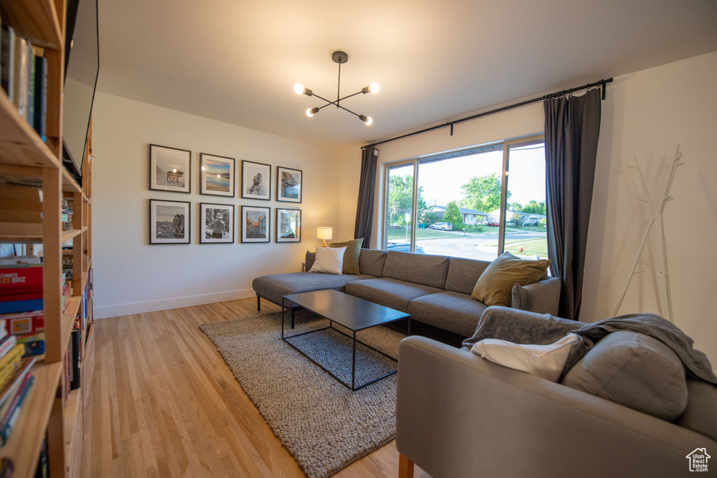 Living room with a chandelier and light wood finished floors