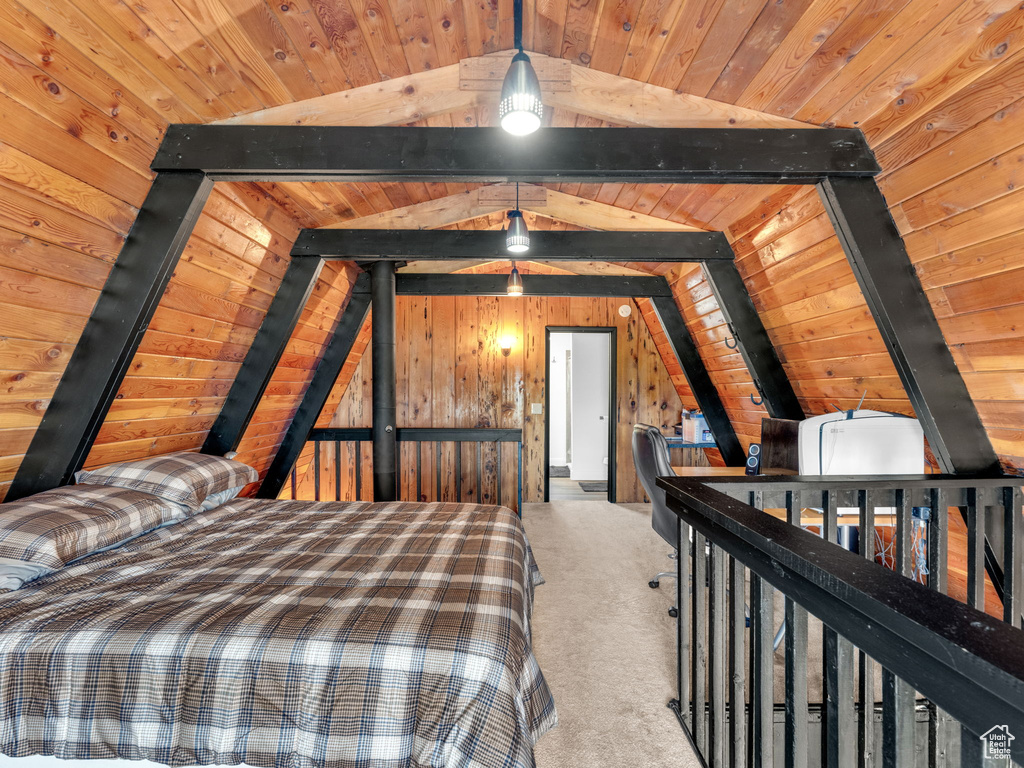 Bedroom featuring wood ceiling, wooden walls, and carpet