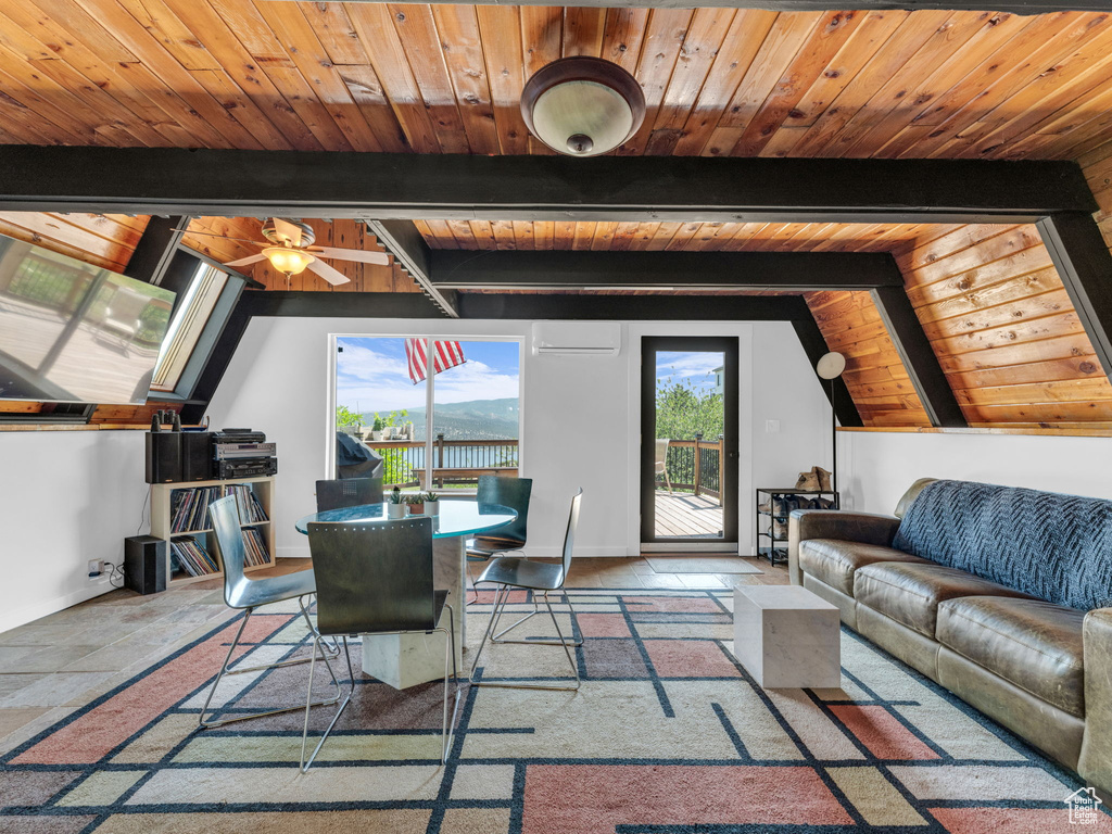 Living area featuring wood ceiling, stone tile floors, and an AC wall unit