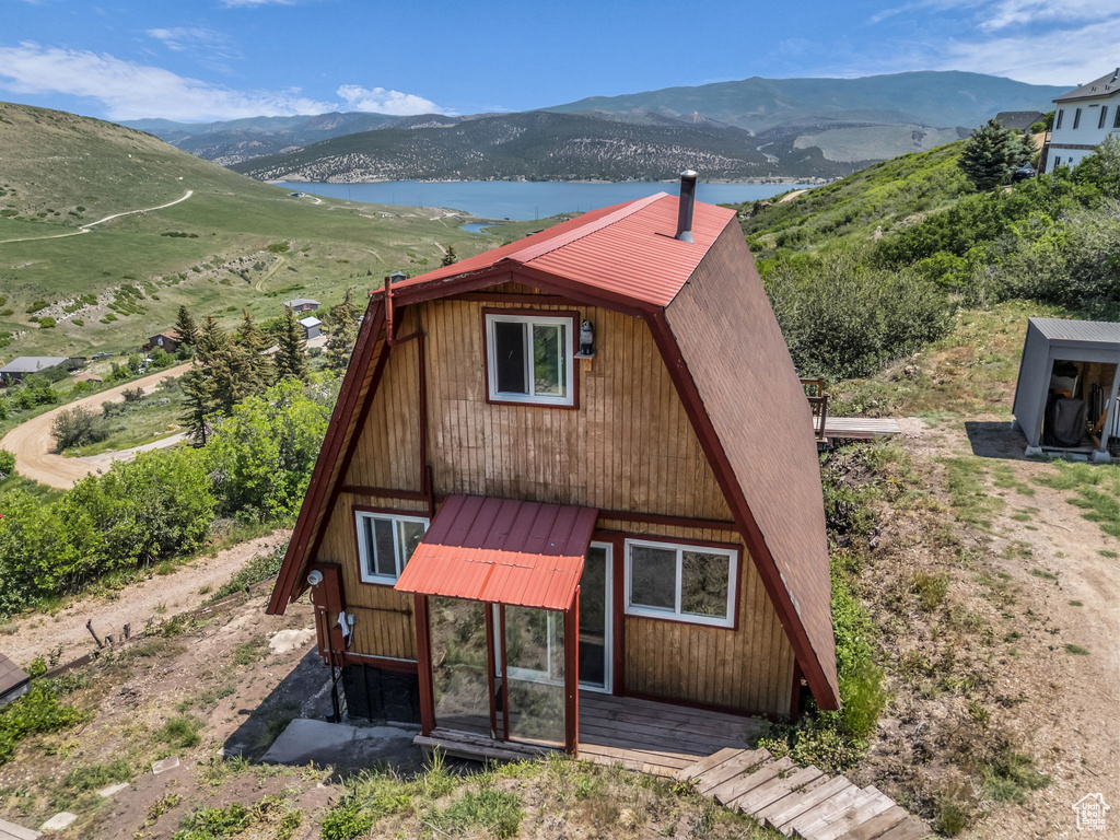 A-frame style home with a metal roof and a water and mountain view