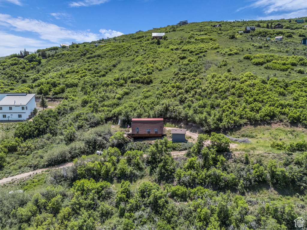 View of subject property with a forest
