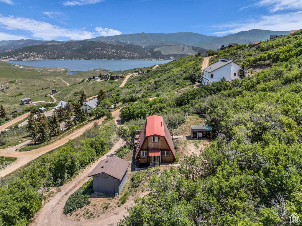 View from above of property with a water and mountain view