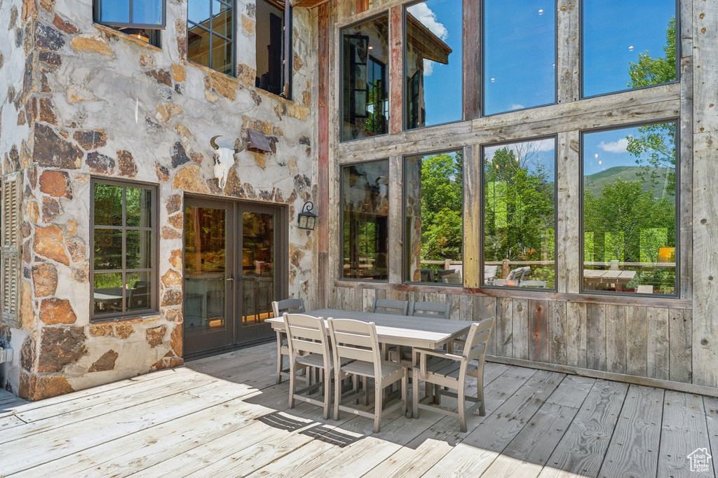 Wooden deck with french doors and outdoor dining space