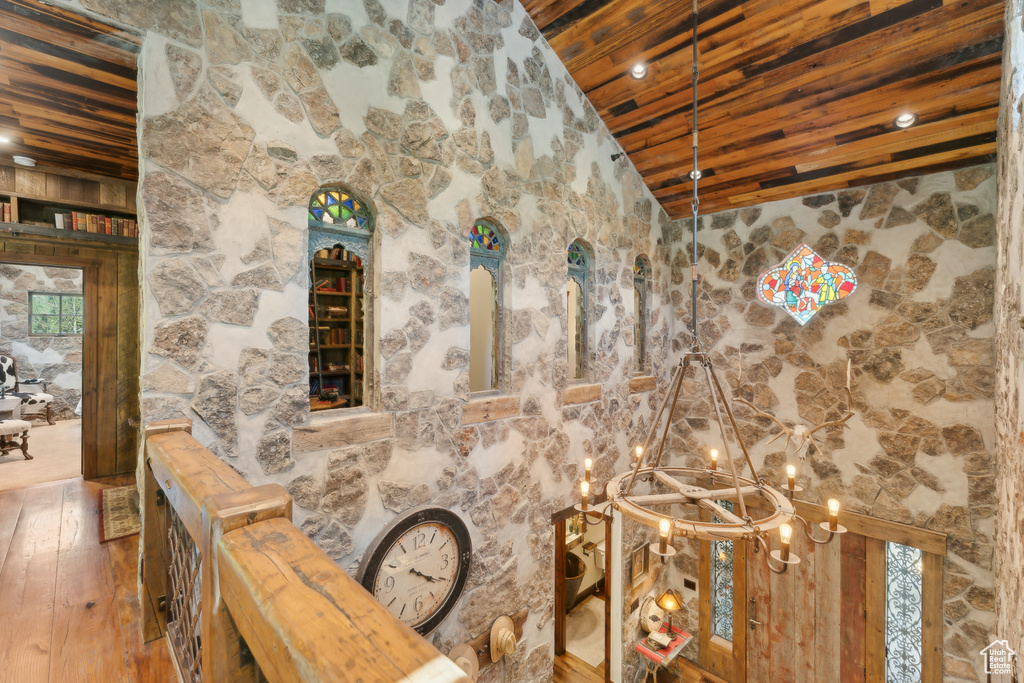 Detailed view of wood ceiling, a chandelier, and wood finished floors