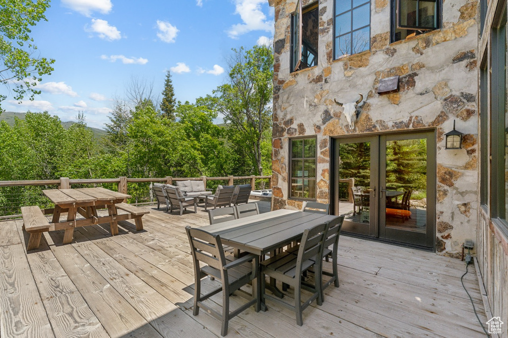 Wooden terrace with outdoor dining area and outdoor lounge area