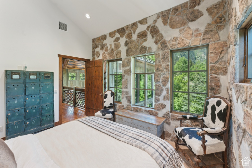 Bedroom with high vaulted ceiling