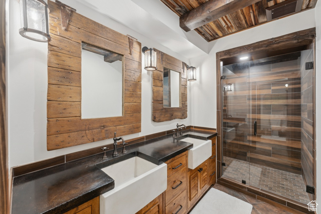 Full bathroom featuring double vanity, a relaxing sauna, a stall shower, a wooden ceiling with exposed beams, and tile patterned flooring