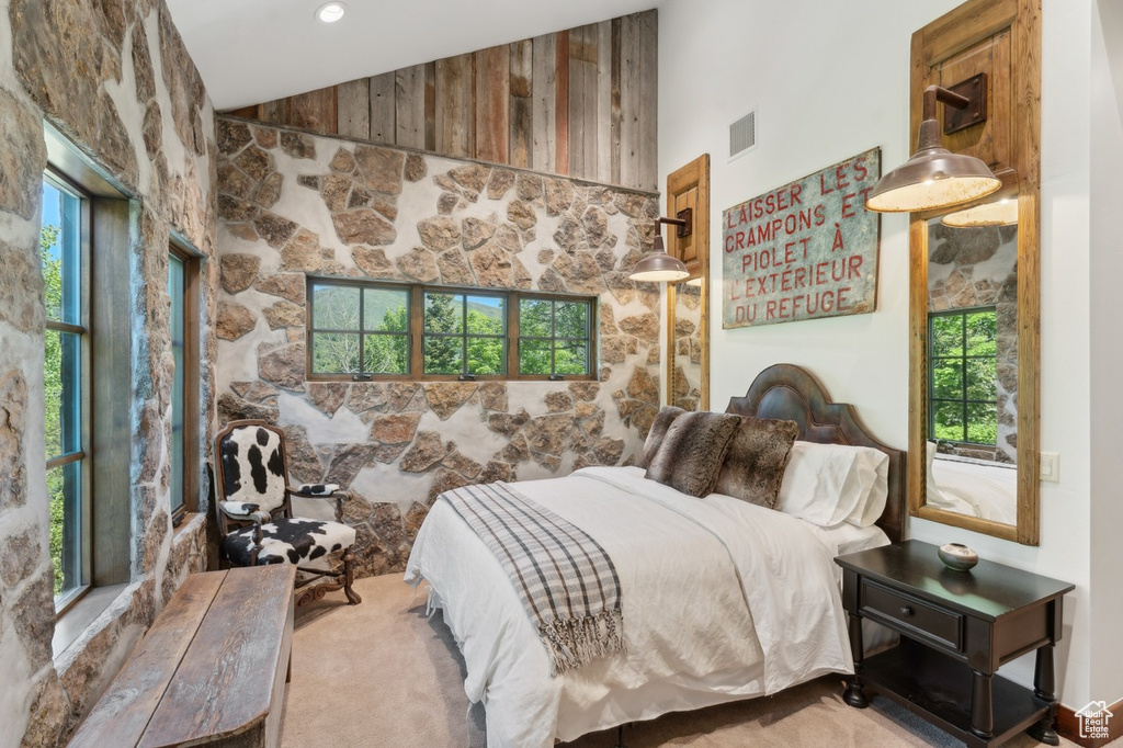 Carpeted bedroom featuring vaulted ceiling