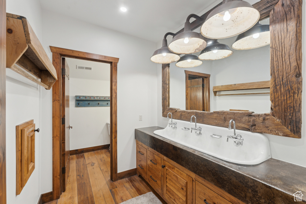 Bathroom featuring wood-type flooring and double vanity