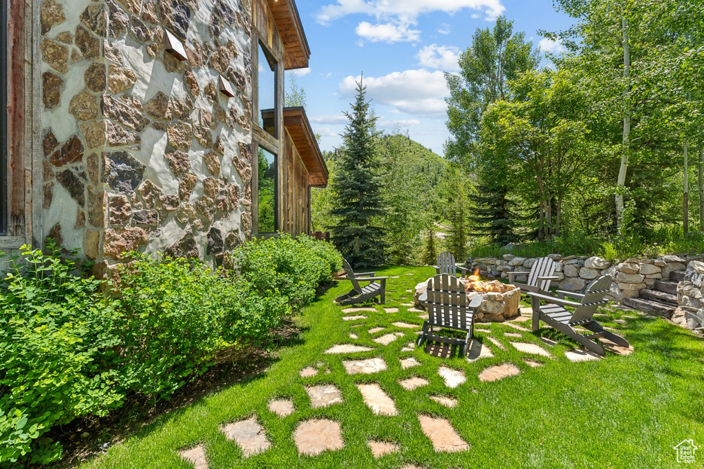 View of green lawn with an outdoor fire pit