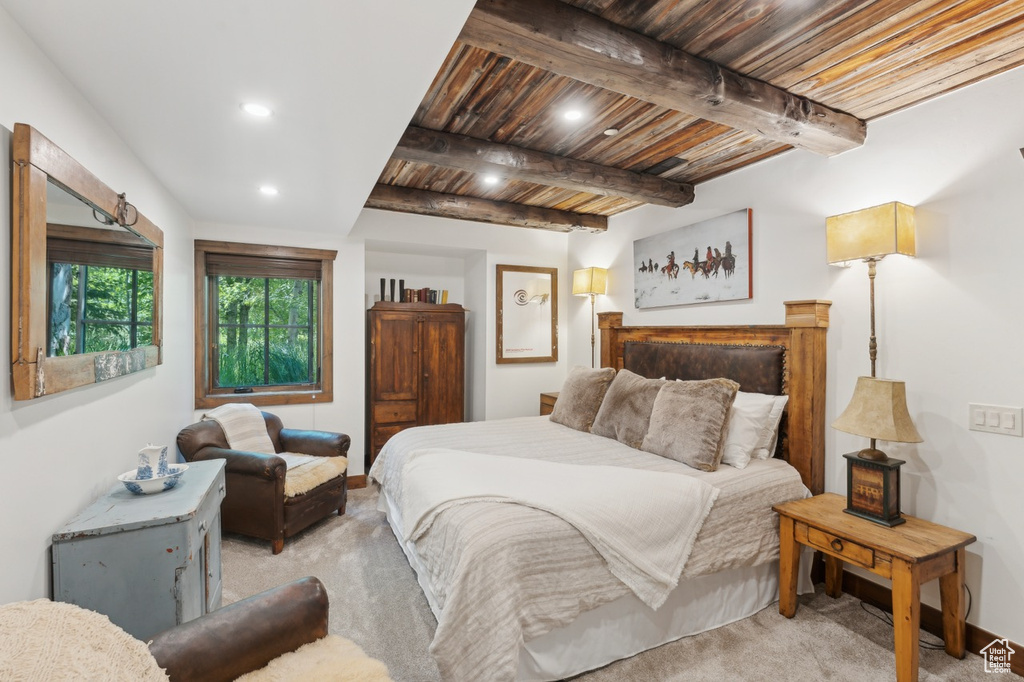 Bedroom with light carpet, recessed lighting, and a wood ceiling with exposed beams