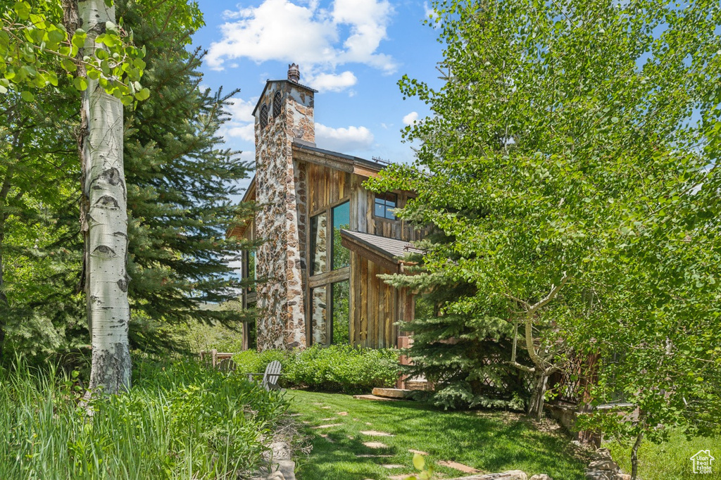 View of property exterior with a chimney