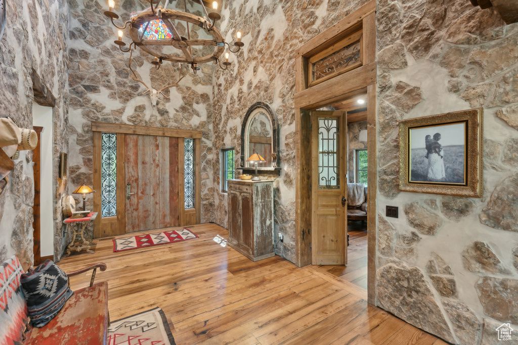 Entryway featuring a chandelier, hardwood / wood-style flooring, and healthy amount of natural light