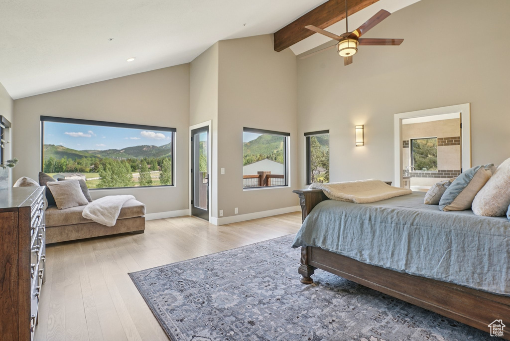 Bedroom featuring light wood-style flooring, high vaulted ceiling, beam ceiling, and ceiling fan