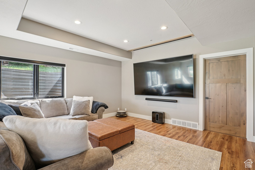 Living room featuring wood finished floors and recessed lighting