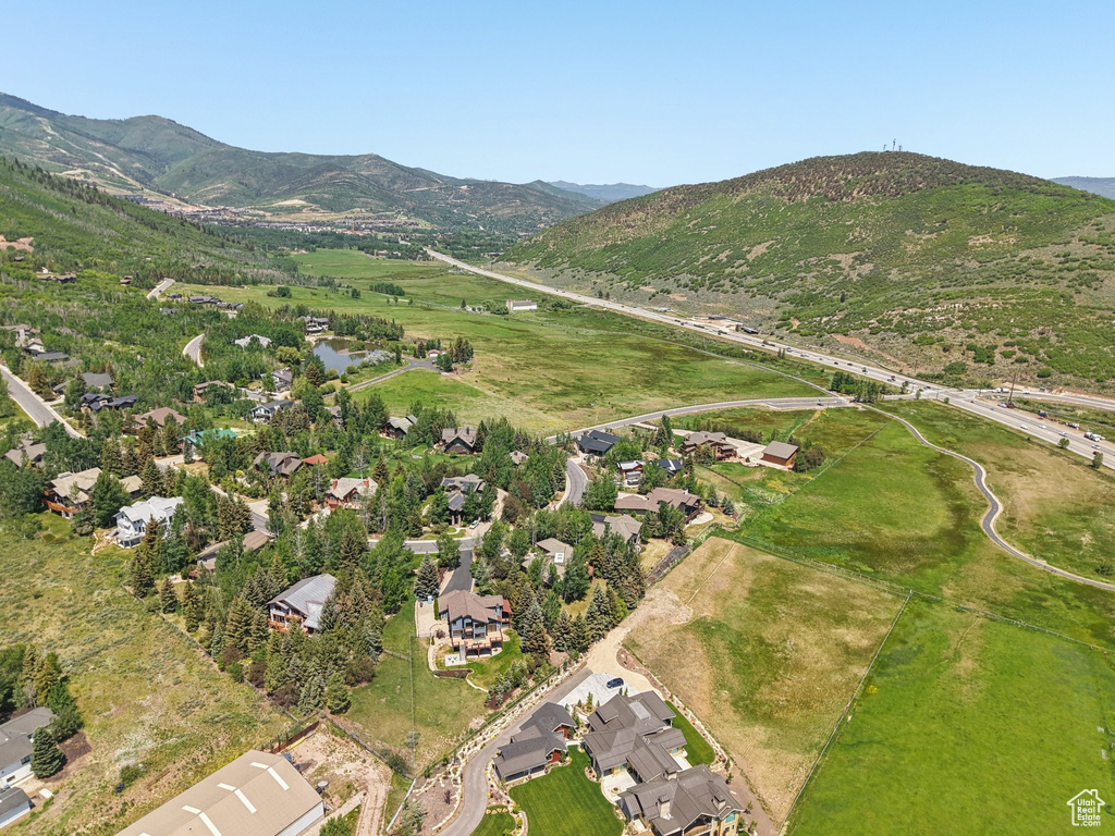 Aerial view of property and surrounding area featuring mountains