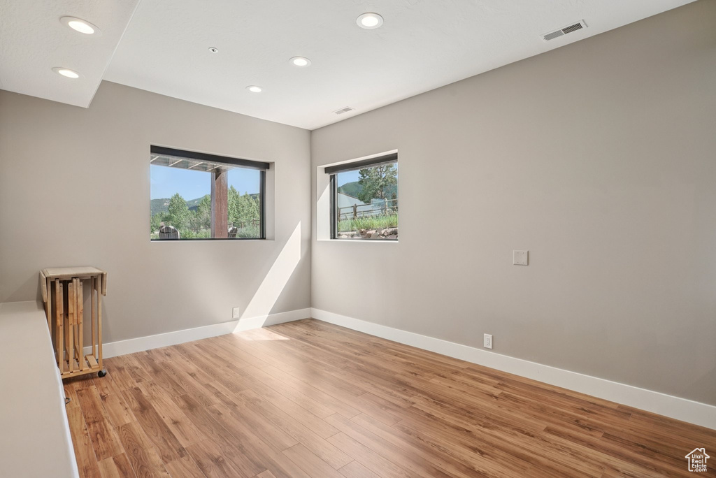 Unfurnished room with recessed lighting and light wood-style floors