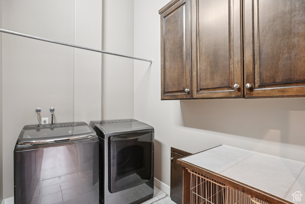Laundry room with cabinet space and independent washer and dryer