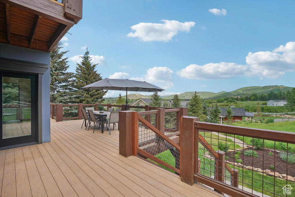 Deck featuring a mountain view and outdoor dining area