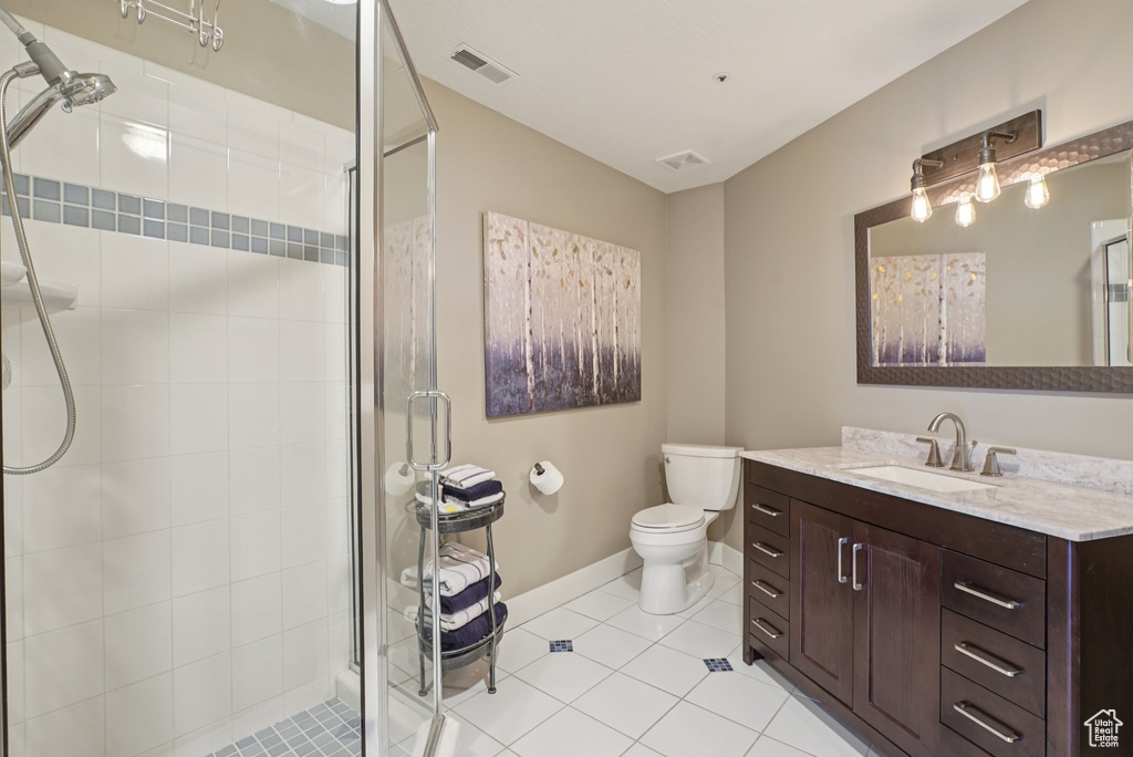 Full bath featuring vanity, a stall shower, and tile patterned flooring