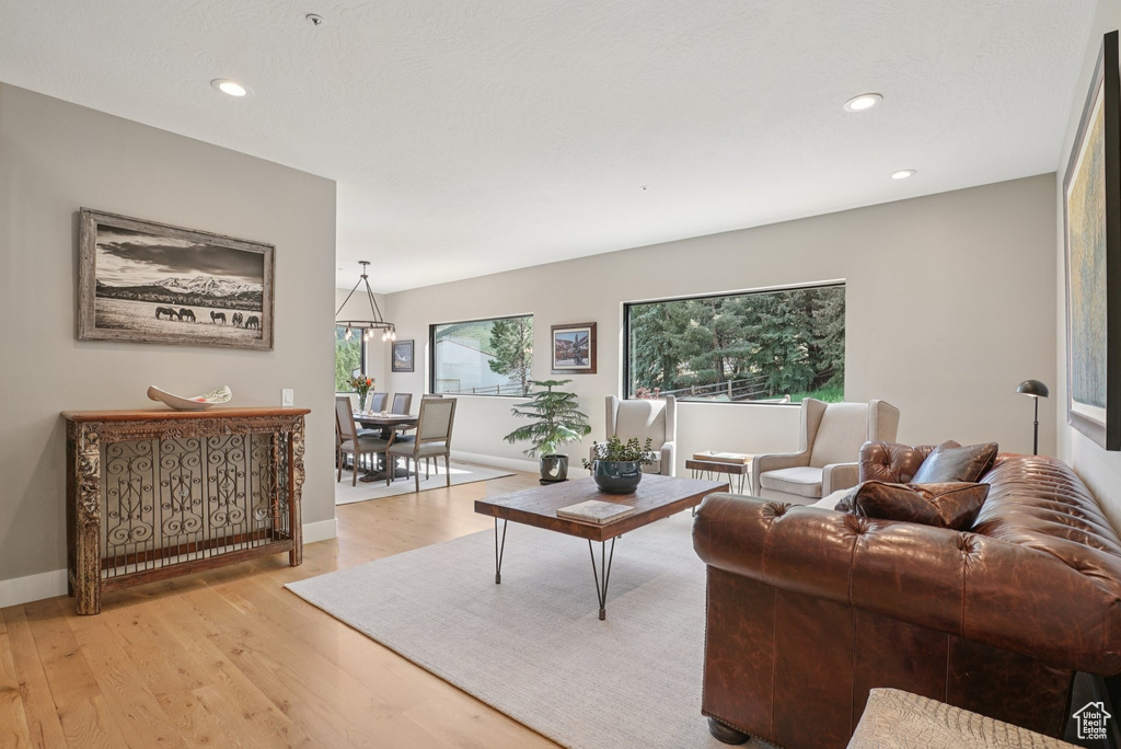 Living room featuring light wood finished floors, plenty of natural light, and recessed lighting