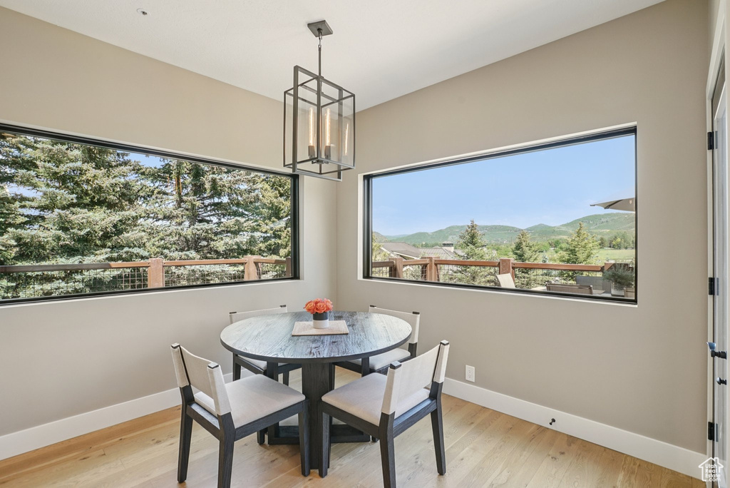 Dining area with a chandelier, wood finished floors, and a mountain view