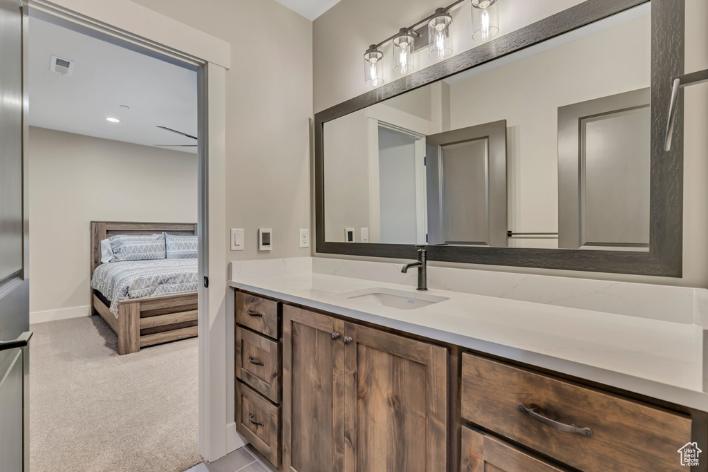 Ensuite bathroom featuring vanity and recessed lighting